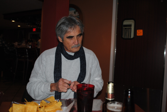 Jim is not a member of the  clergy, but it looks as though he is either praying that our car made it to the restaurant or that we would be able to eat the sub par food.