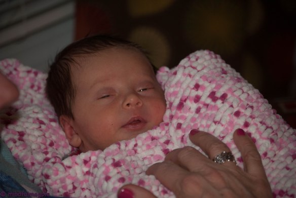Lillian in the blanket I barely finished before she was born.